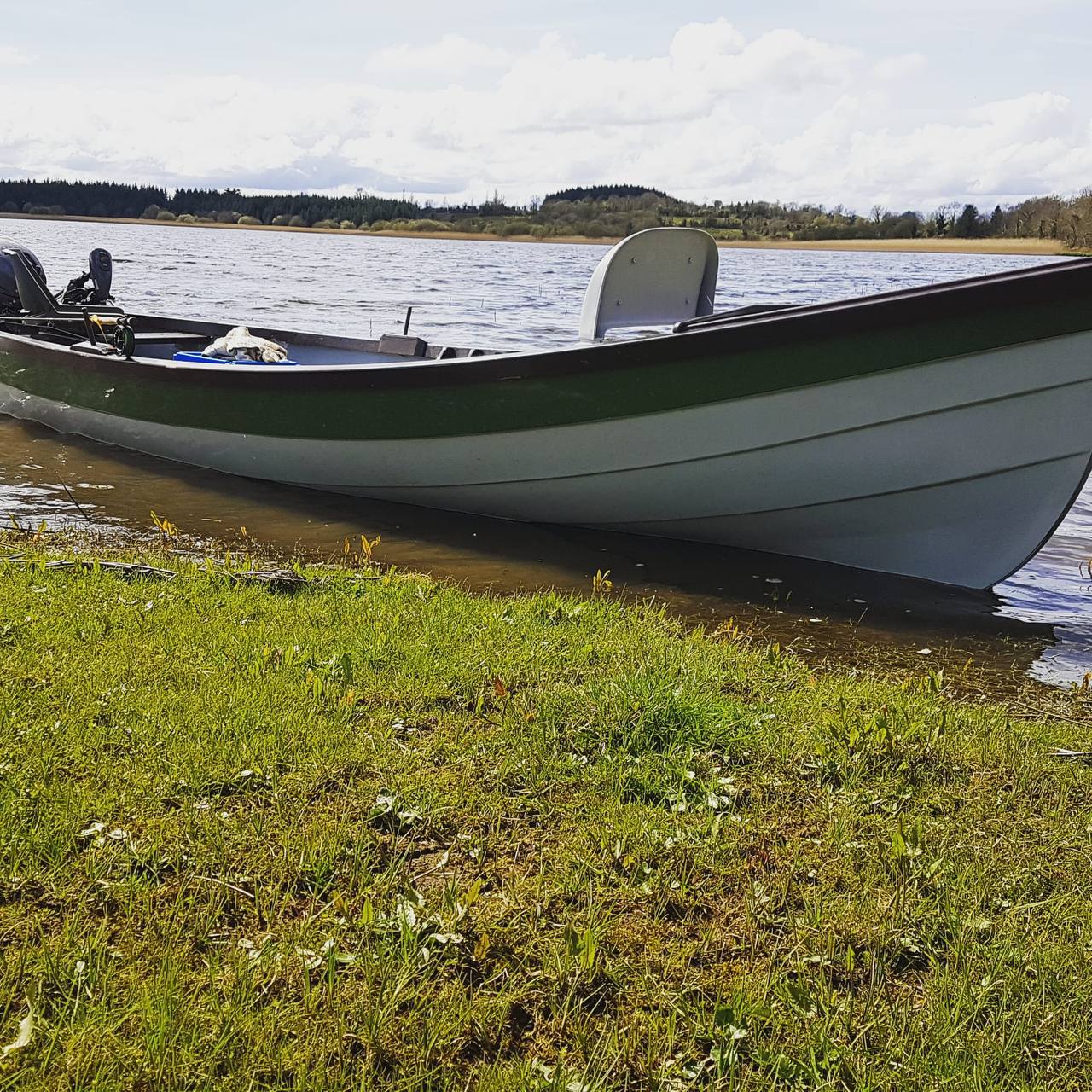 The boat on a calm, sunlit Lough Erne